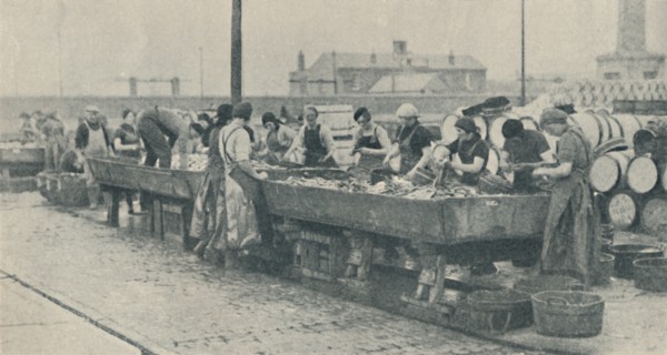 'An Important Part of the Industry. Scottish girls busy gutting at Yarmouth', 1937. Artist: Unknown.