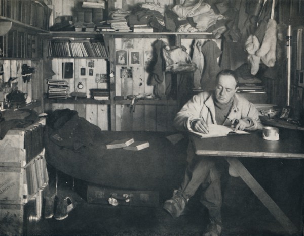 'Captain Scott Writing His Diary in the Hut at Cape Evans', c1911, (1914). Creator: Herbert Ponting.