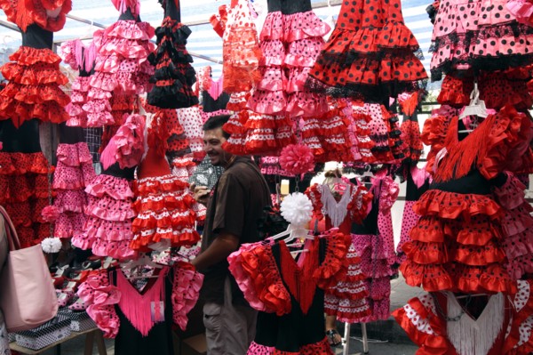Colourful flamenco dresses for sale in a market, Mallorca, Spain.