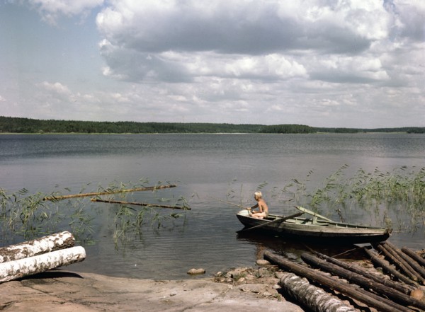 A boy fishing from a rowing boat during his summer holidays, Sweden, 1950s. Artist: Göran Algård