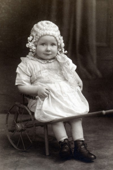 A little girl in a cart, c1910. Artist: Unknown