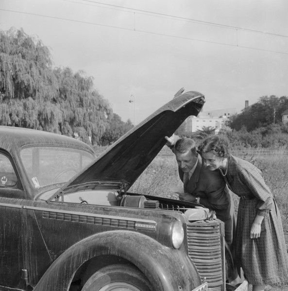 Checking the engine under the bonnet of an Opel Olympia, Landskrona, Sweden, 1959. Artist: Unknown