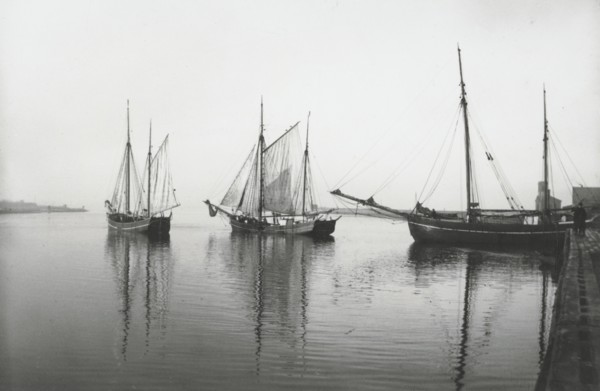 Sailing ships leave the harbour of Landskrona in dead calm conditions, Sweden, 1903. Artist: Unknown