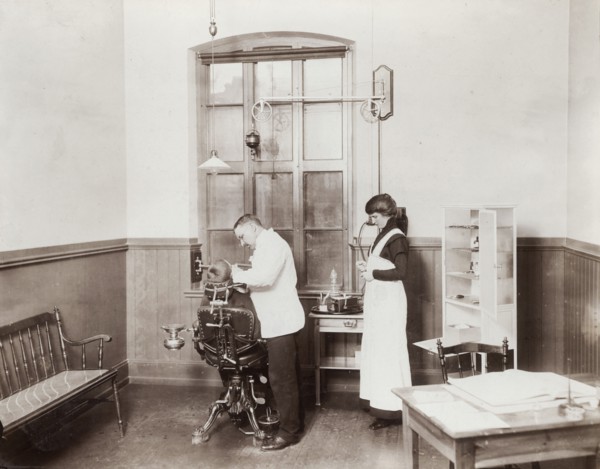A dentist and his nurse give a schoolboy his treatment, 1910s. Artist: Unknown