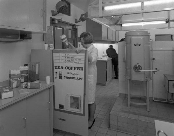 Loading a drinks vending machine at an experimental kitchen in Sheffield, South Yorkshire, 1966. Artist: Michael Walters