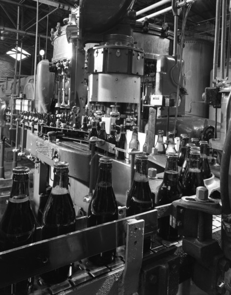 Beer bottles being filled at Ward & Sons, Swinton, South Yorkshire, 1960. Artist: Michael Walters