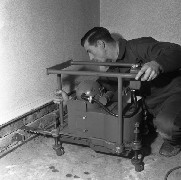 Installing a damp proof course in a house in Goldthorpe, South Yorkshire, 1957.  Artist: Michael Walters