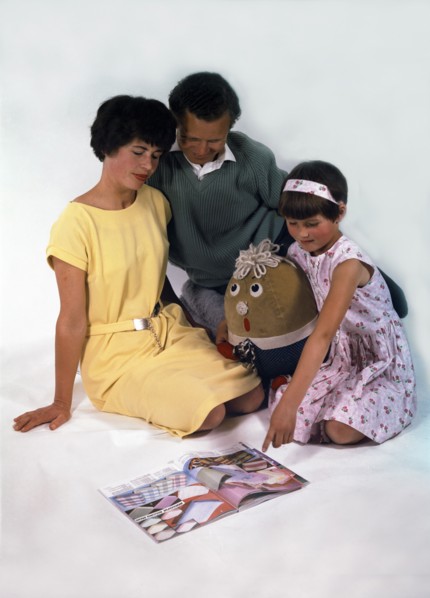 Family group looking at a magazine, 1963. Artist: Michael Walters