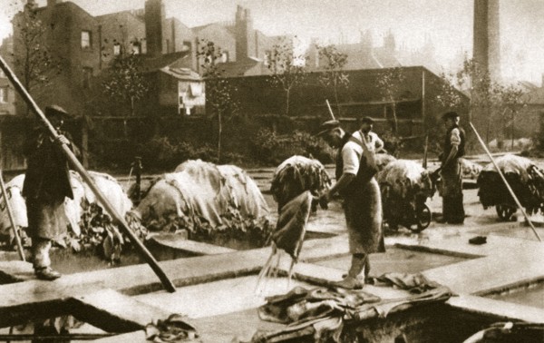 Making leather in the lime yard at Neckinger Mills, London, 20th century. Artist: Unknown