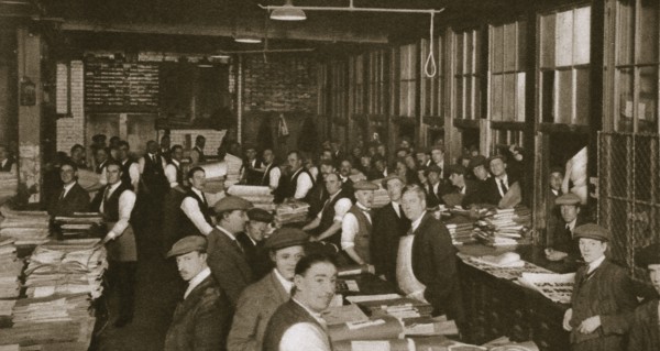 Newsvendors gather to pick up the next day's newspapers to sell, Carmelite House, 20th century. Artist: Unknown