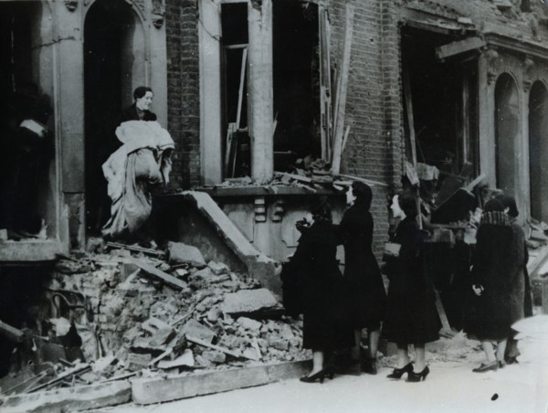 A woman collects her belongings from a bombed house, London, World War II, c1940-c1945. Artist: Unknown