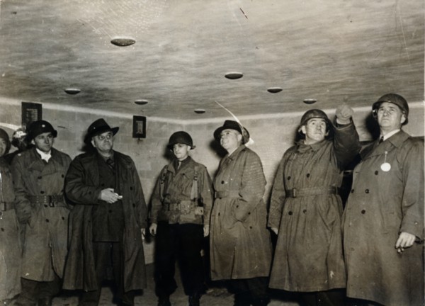 American soldiers examine a gas chamber, Dachau concentration camp, Bavaria, Germany, c1945. Artist: Unknown