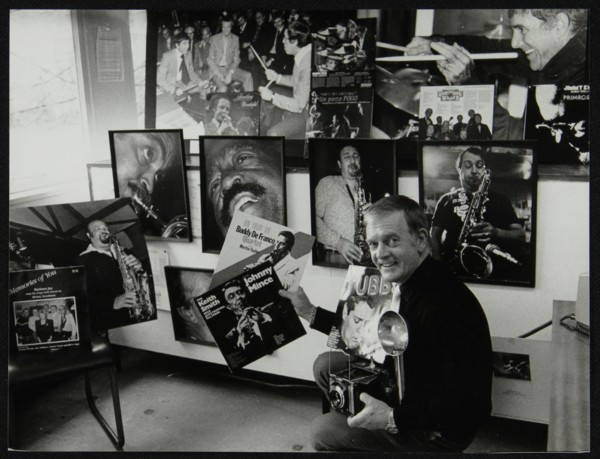 Photographer Denis Williams holding an LP cover. Artist: Unknown
