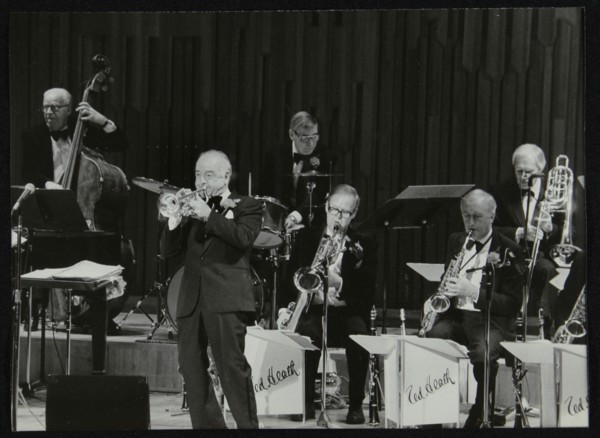 The Ted Heath Orchestra in concert, London 1985. Pictured are Lennie Bush (double bass), Kenny Baker Artist: Denis Williams