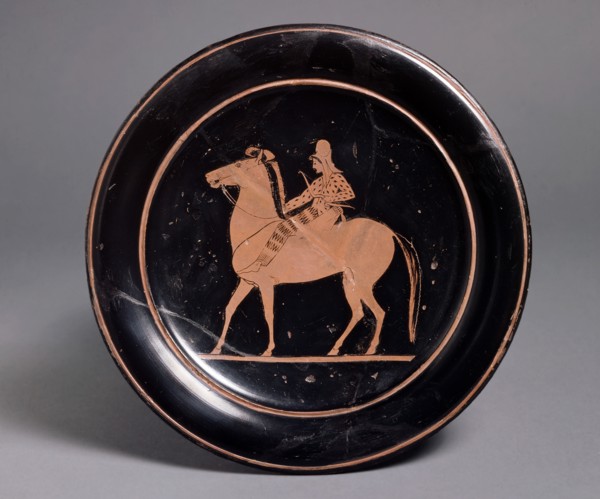 Attic red-figure plate showing a mounted archer in oriental costume in the interior, inscribeld Mil Artists: Unknown, Paseas.