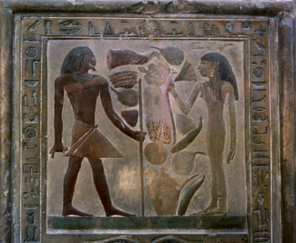 Door shaped stela representing Senouret and his wife in front of their offerings, made in polychr?
