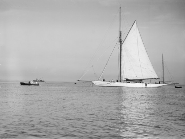 Sailing yacht 'Bona' being towed, 1912. Creator: Kirk & Sons of Cowes.