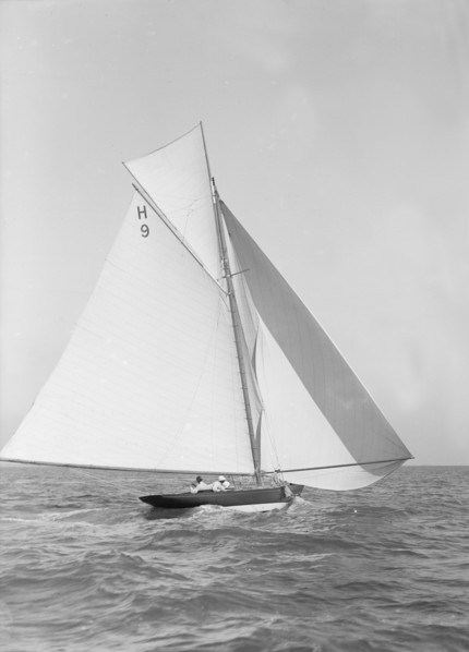 The 8 Metre class 'Termagent' (H9) sailing with spinnaker, 1911. Creator: Kirk & Sons of Cowes.