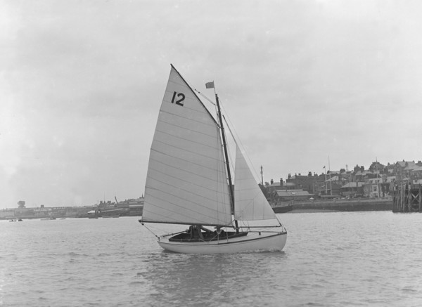 A Hamble River Class dinghy (No 12) sailing close-hauled, 1921. Creator: Kirk & Sons of Cowes.