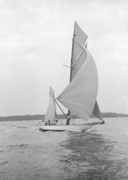 The 8-metre 'Ierne' sailing with spinnaker, 1913. Creator: Kirk & Sons of Cowes.