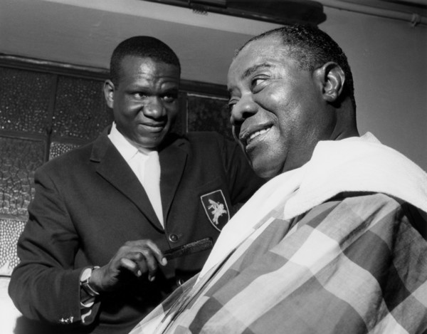 Louis Armstrong having haircut in Hammersmith, London, 1962.