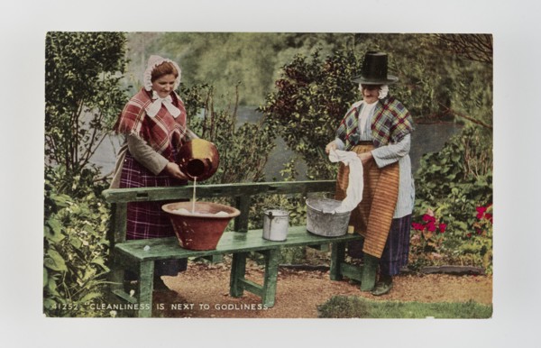 Cleanliness is next to Godliness.  Women in Welsh costume washing in tubs on bench, c1900s