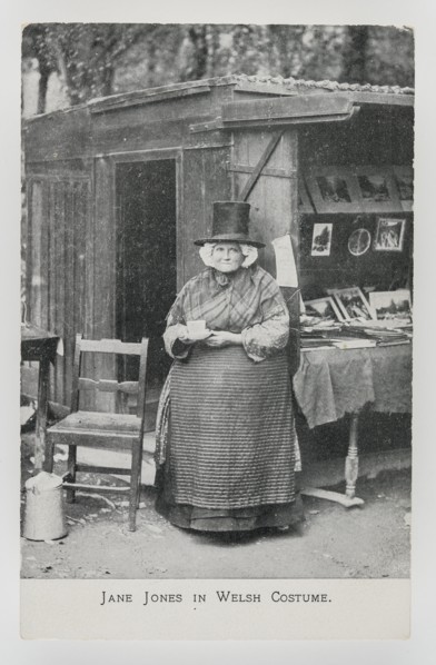 Jane Jones in Welsh Costume at her bookstall in Betws-y-coed, c1910.
