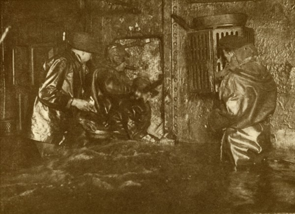 Divers Plugging A Leak During Salvage Operations Waist-Deep In Water On the Lower Decks Of The Germ