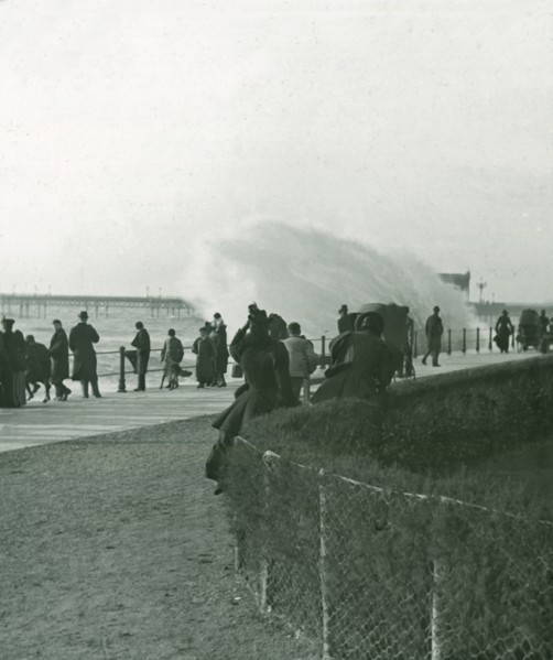 Rough sea over the promenade at Hastings, Sussex, late 19th-early 20th century.