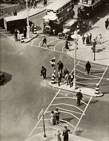 Traffic and pedestrians in Trafalgar Square, London