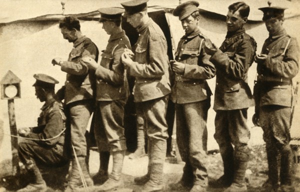 British soldiers synchronising their watches on the front line, First World War, 1914-1918, (1933). Creator: Unknown.