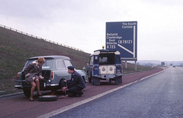 Austin A40 Farina having wheel changed by R.A.C breakdown assistance. Creator: Unknown.