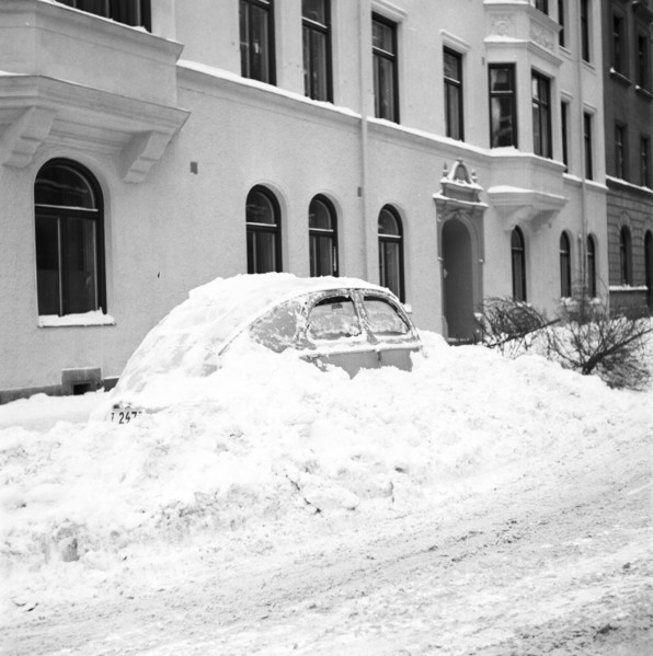 Snow in a car at telephone booth in Stockholm, Sweden, January 1954. Creator: Unknown.