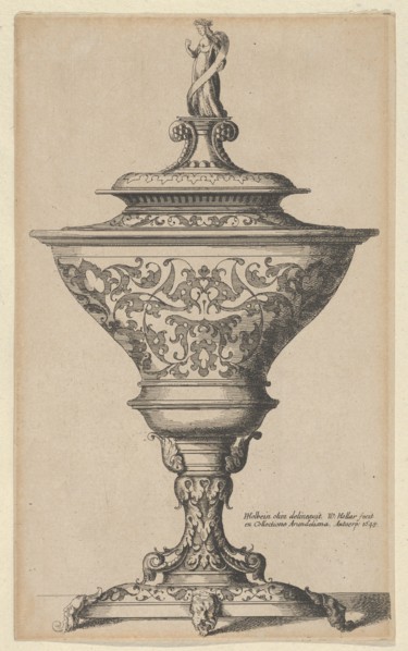 Ornate goblet on feet of masks