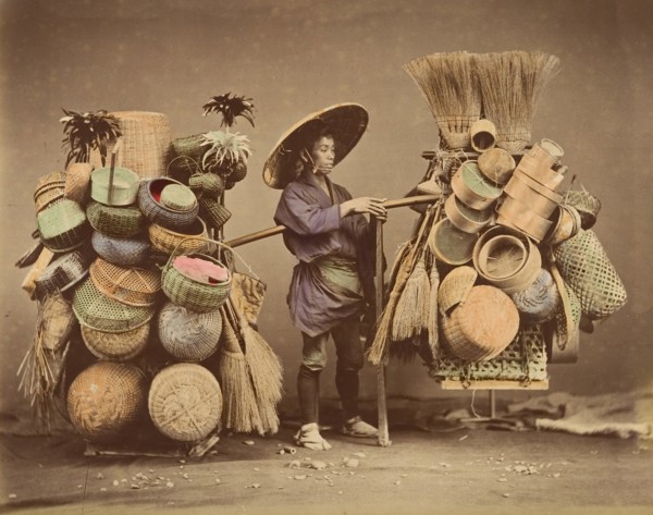 [Japanese Man Posing with Baskets, Brooms and Feather Dusters], 1870s.