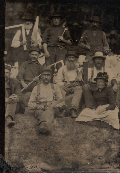 A Woman and Eight Carpenters Posed Outdoors, 1880s.