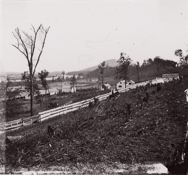 [White picket fence with buildings in background]. Brady album, p. 123, 1861-65. Formerly attributed to Mathew B. Brady.