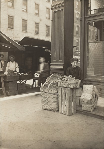 Lena Lochiavo - 11 years old, basket (and pretzel) seller, at Sixth Street Market in front of saloon entrance, Cincinnati, Ohio, 3136.