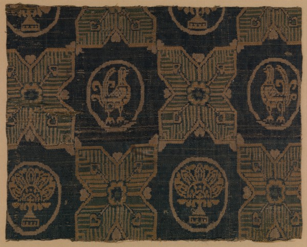 Textile Fragment, probably Iran, 8th-9th century. Four-pointed stars, in between  roundels bearing stylized florals and birds.