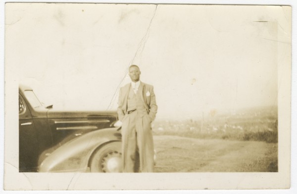 Photograph of an unidentified man in front of car, ca. 1920. Creator: Unknown.