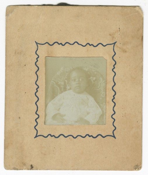 Photograph of a baby dressed in white and sitting in a chair, ca. 1870. Creator: Unknown.