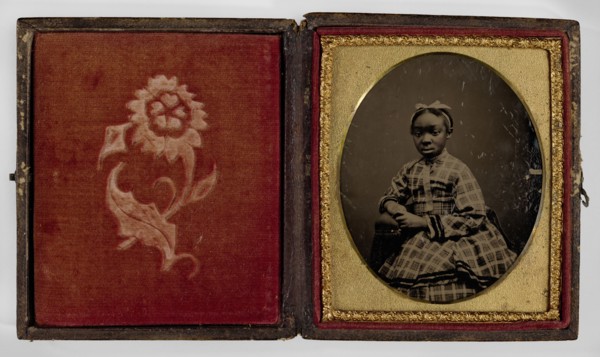 Tintype of a girl in a plaid dress, 1870s. Creator: Unknown.