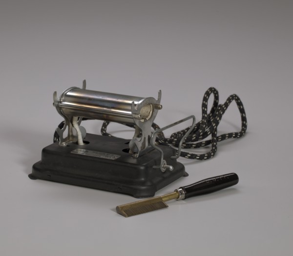 Electrical hot comb heater and hot comb, 1920s. Creator: Unknown.