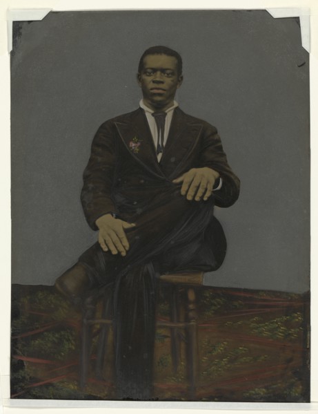 Tintype of a man wearing a suit with a pendant on the lapel, early 20th century. Creator: Unknown.