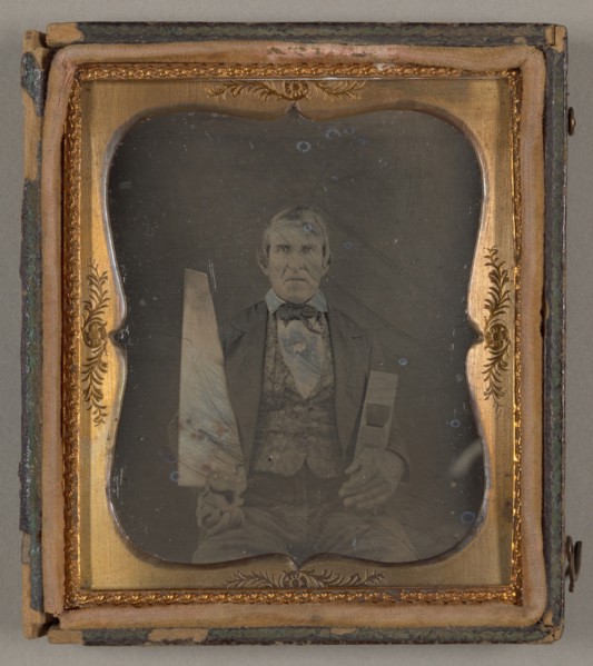 Untitled [portrait of a man holding carpentry tools], 1839/99.  Creator: Unknown.