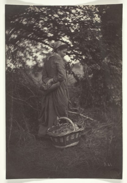 Woman Standing with Basket on Ground, 1870. Creator: Giraudon's Artist.