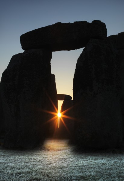 View of Stonehenge, showing the sun's rays glinting through the opening in a trilithon, 2012. Creator: James O Davies.