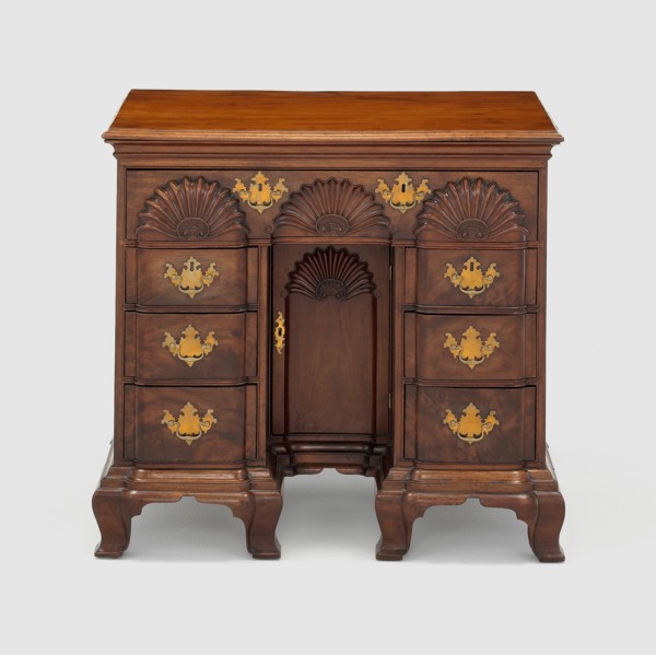 Bureau Table, c. 1770. Small wooden bureau with carved half-circle designs, gilded handles. Attributed to John Townsend.