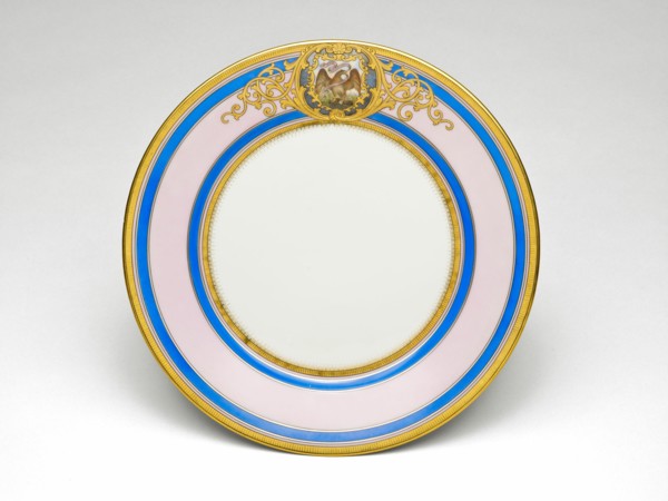 Illinois Plate, c. 1878/89. Porcelain plate painted with gold, filigree-patterned cartouche, bald eagle with the Illinois state motto, 'State Sovereignty, National Union'. Decorated by Joseph S. Potte...
