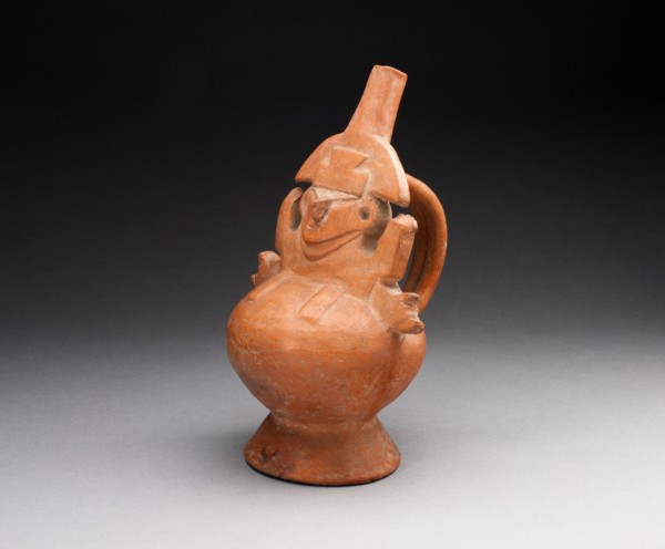 Single Spout Vessel with Molded Abstract Figure, A.D. 1000/1476. An orange-red ceramic vessel in the shape of an abstract figure with wide-set eyes and short arms, a handle at back.